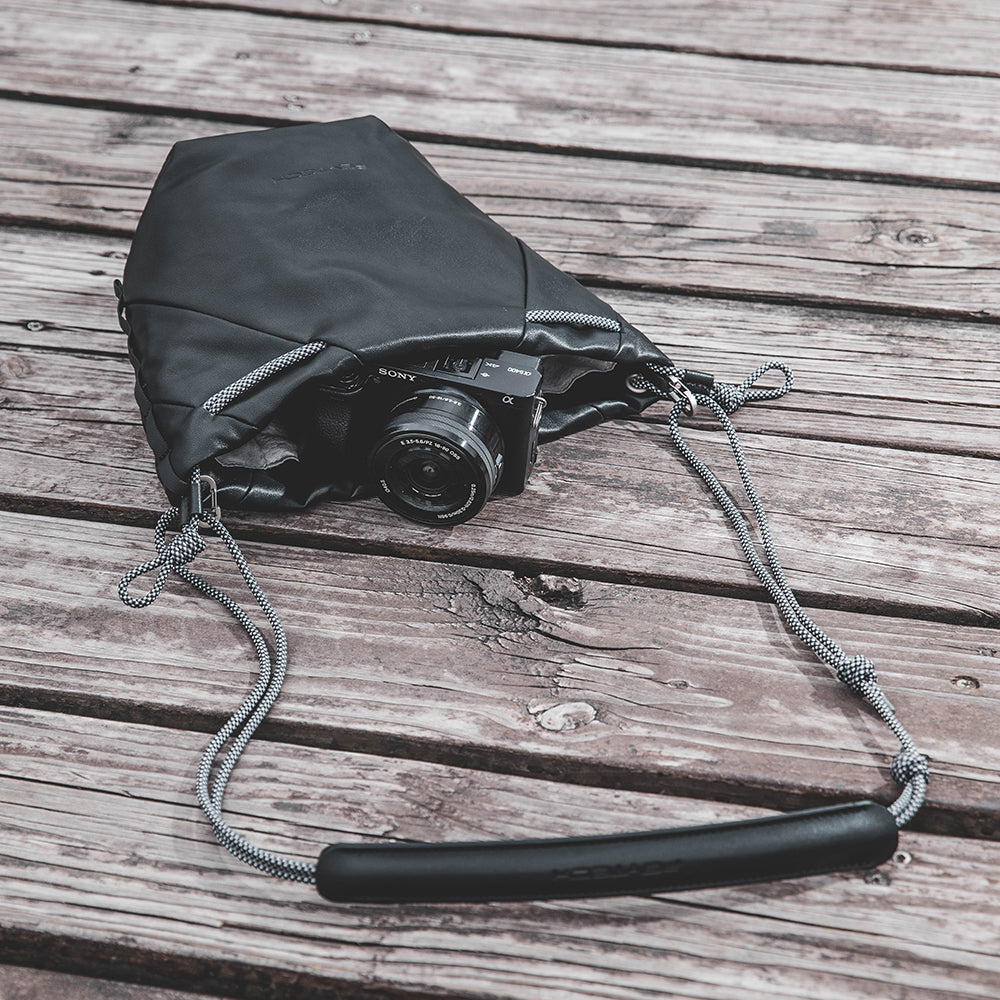 Safeguard your camera gear with the OneGo Drawstring Bag. Featuring a robust Multi-Layer Bump Shield​ interior, this bag provides superior impact resistance and reliable protection for your photography equipment.