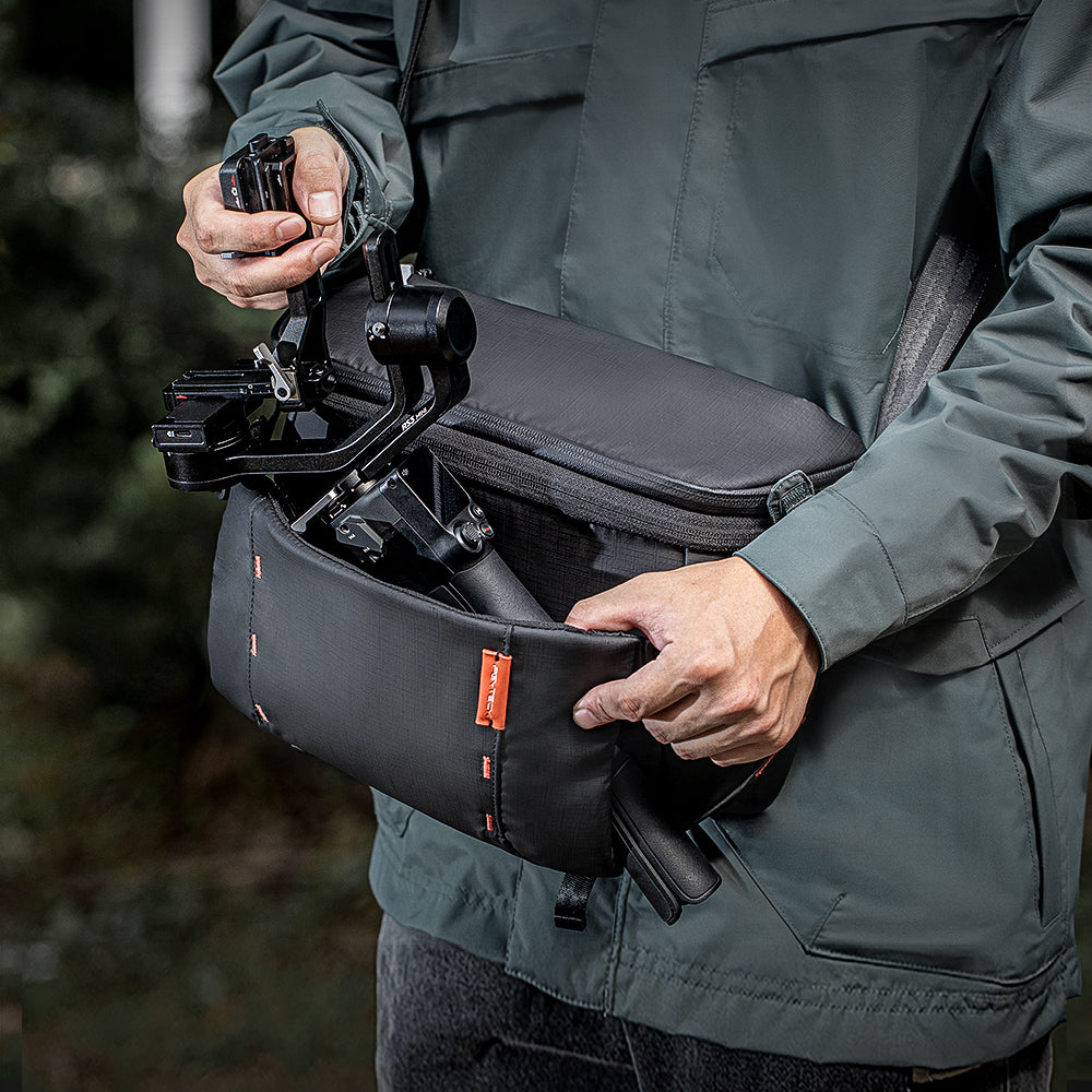 The OneMo Sling Stows Your Handheld Stabilizer in Its Middle Sleeve.