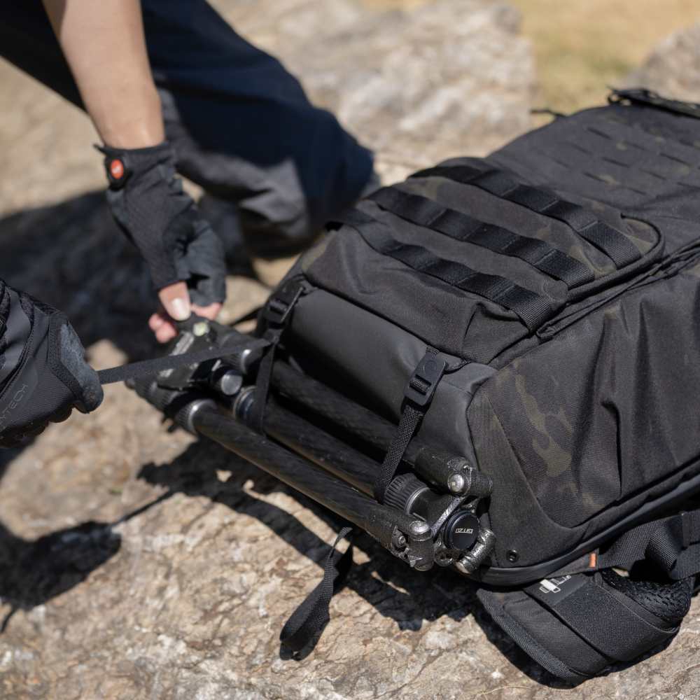 The included compression straps of OneMo Tactical BackPack can secure tripods and other items onto the bottom attachment points.