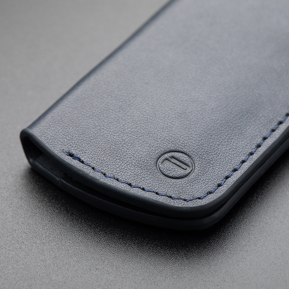 memory-card-wallet-deep-navy-has an embossed buttermilk skin exterior and microfiber inner lining.